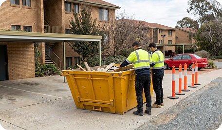 Skip Bins Canberra team preparing to transport a full skip bin from a Watson residential renovation site to a waste facility